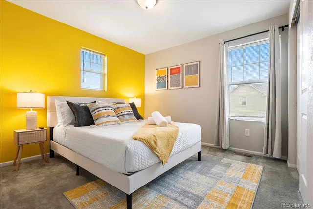 a bedroom with a bed and wall painting