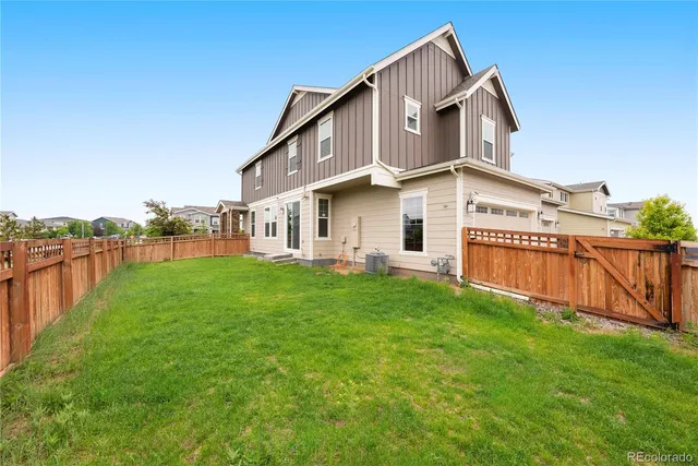 a view of a house with a yard and sitting area