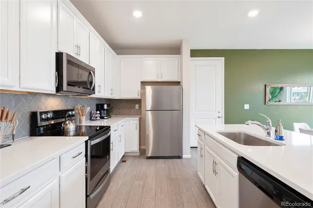 a kitchen with a sink a stove and refrigerator