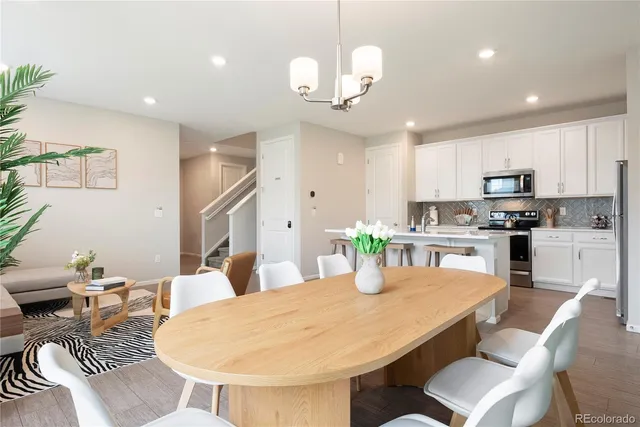 a kitchen with kitchen island granite countertop a sink and refrigerator