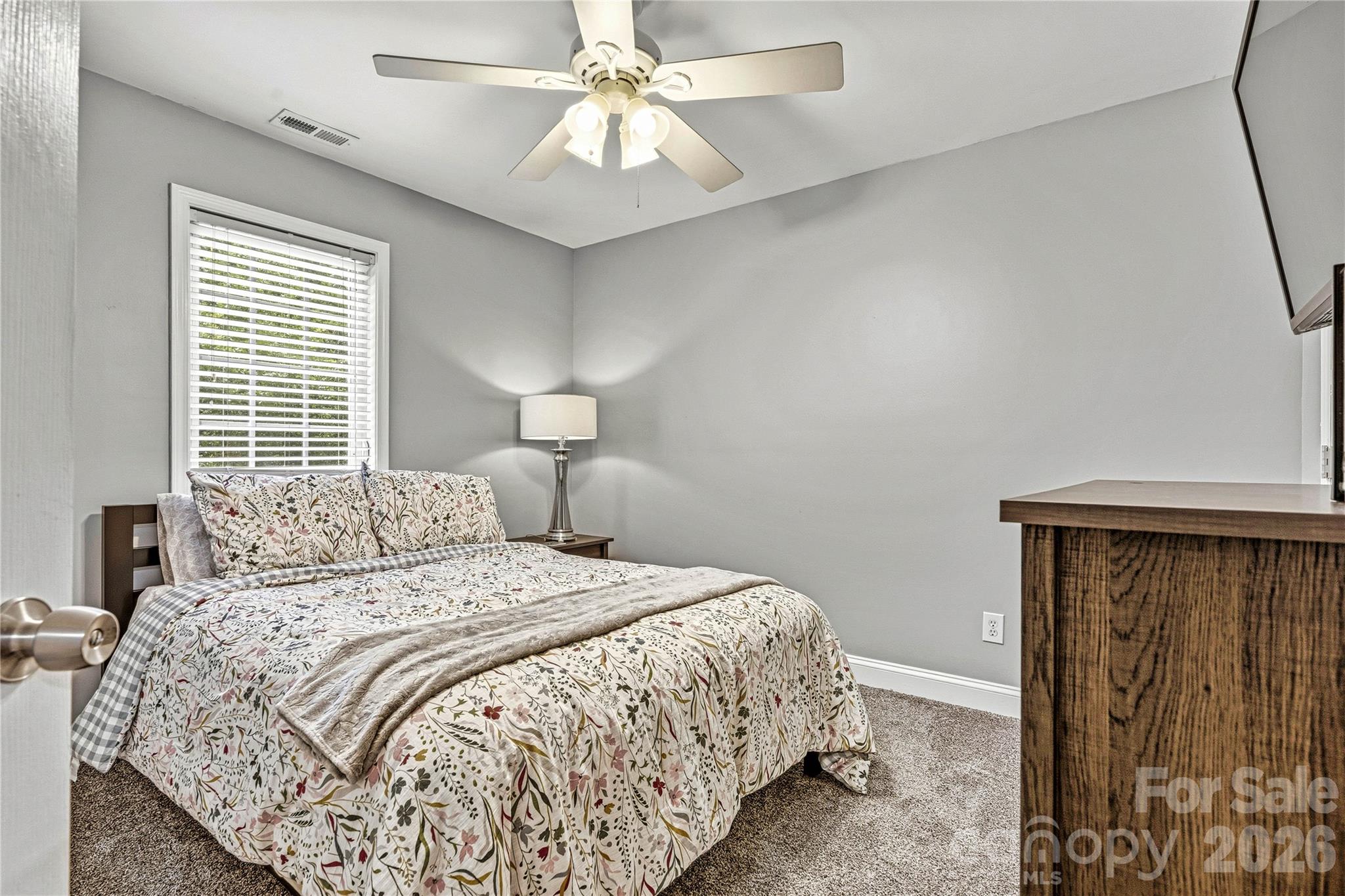 1606 High Ridge Drive Stanley, NC 28164 - Photo 27 of 44 a bedroom with a bed and a chandelier