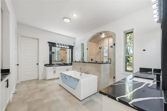 a large white kitchen with a large window