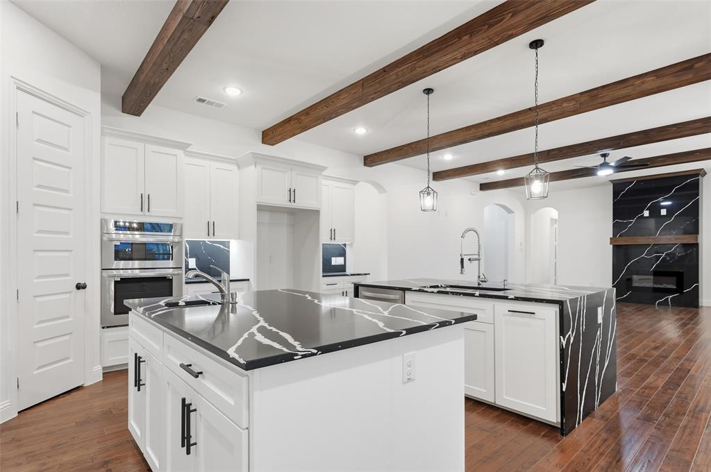 300 Seacross Court Combine, TX 75159 - Photo 31 of 39 a kitchen that has a sink a stove and cabinets