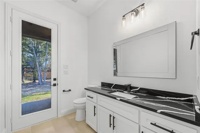 a kitchen that has a sink a stove and cabinets