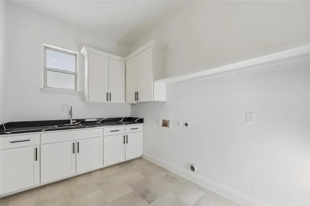 a bathroom with a granite countertop sink a toilet and a mirror