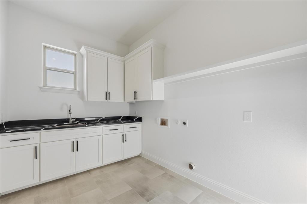 300 Seacross Court Combine, TX 75159 - Photo 33 of 39 a kitchen with granite countertop white cabinets and sink