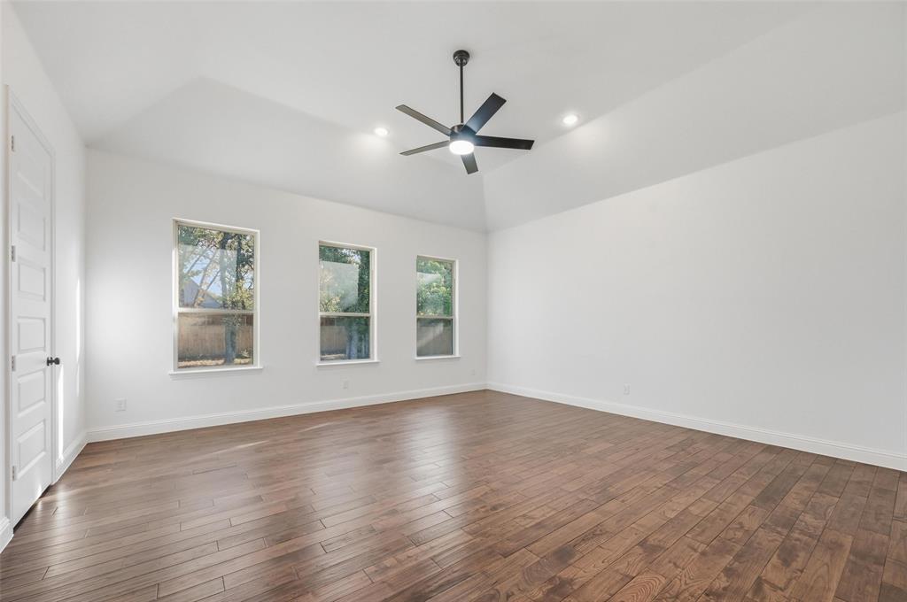 300 Seacross Court Combine, TX 75159 - Photo 34 of 39 an empty room with wooden floor ceiling fan and windows