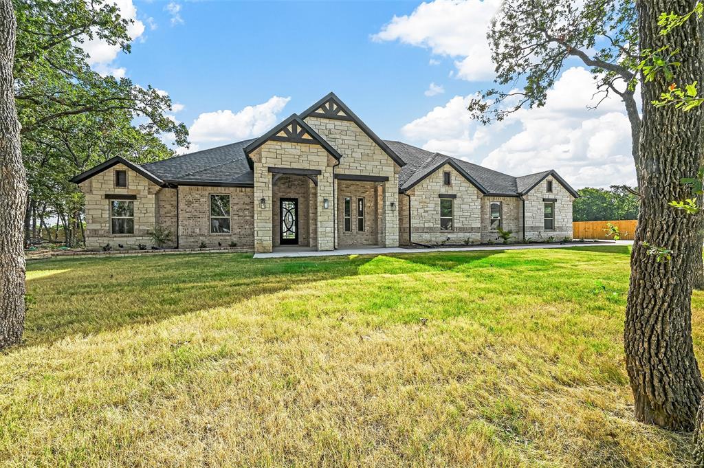 300 Seacross Court Combine, TX 75159 - Photo 4 of 39 a front view of a house with a garden and trees