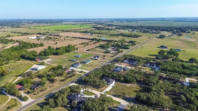 an aerial view of ocean and residential houses