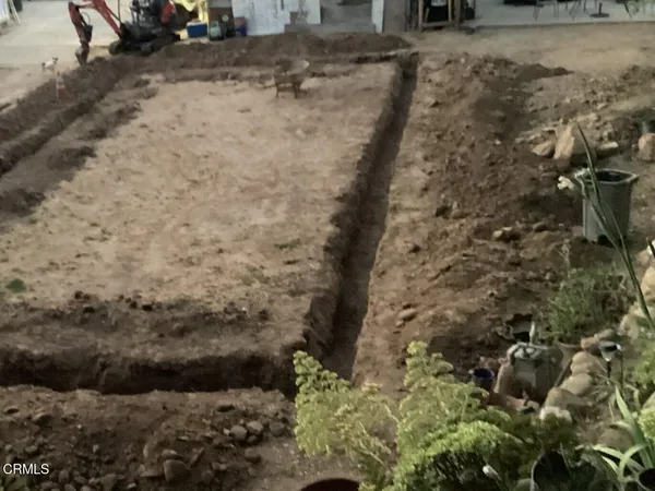 a view of a yard with wooden fence
