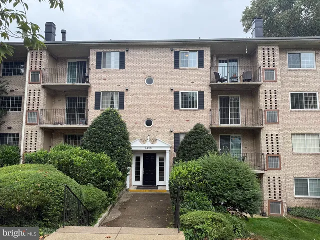 a front view of a house with plants