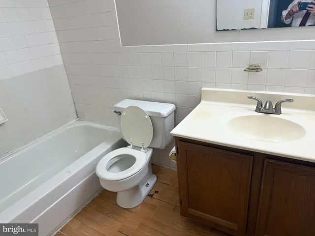 a white toilet sitting next to a bathroom sink