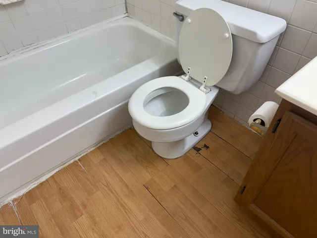 a bathroom with a toilet and a tub