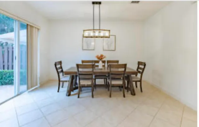 a view of a dining room with furniture and chandelier