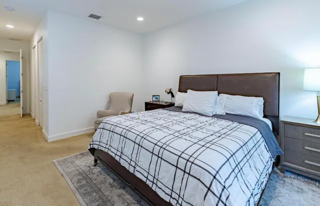 a bedroom with a bed and a mirror