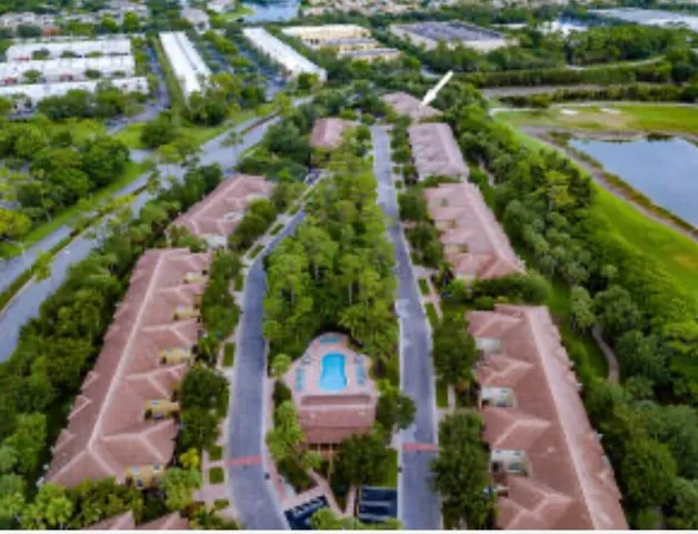 an aerial view of a house with outdoor space
