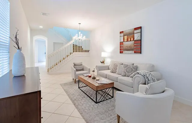 a living room with furniture and a painting