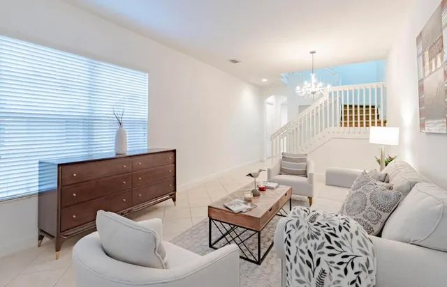 a living room with furniture and a chandelier