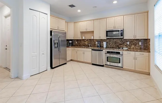 a kitchen with cabinets and steel stainless steel appliances