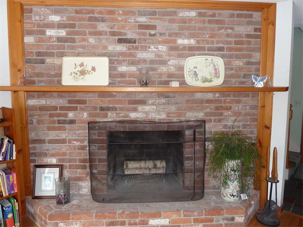 257 Stafford Road Monson, MA 01057 - Photo 1 of 1 a fireplace with a clock on top of it