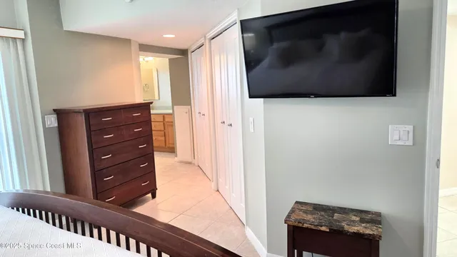 a view of a hallway with front door and wooden floor