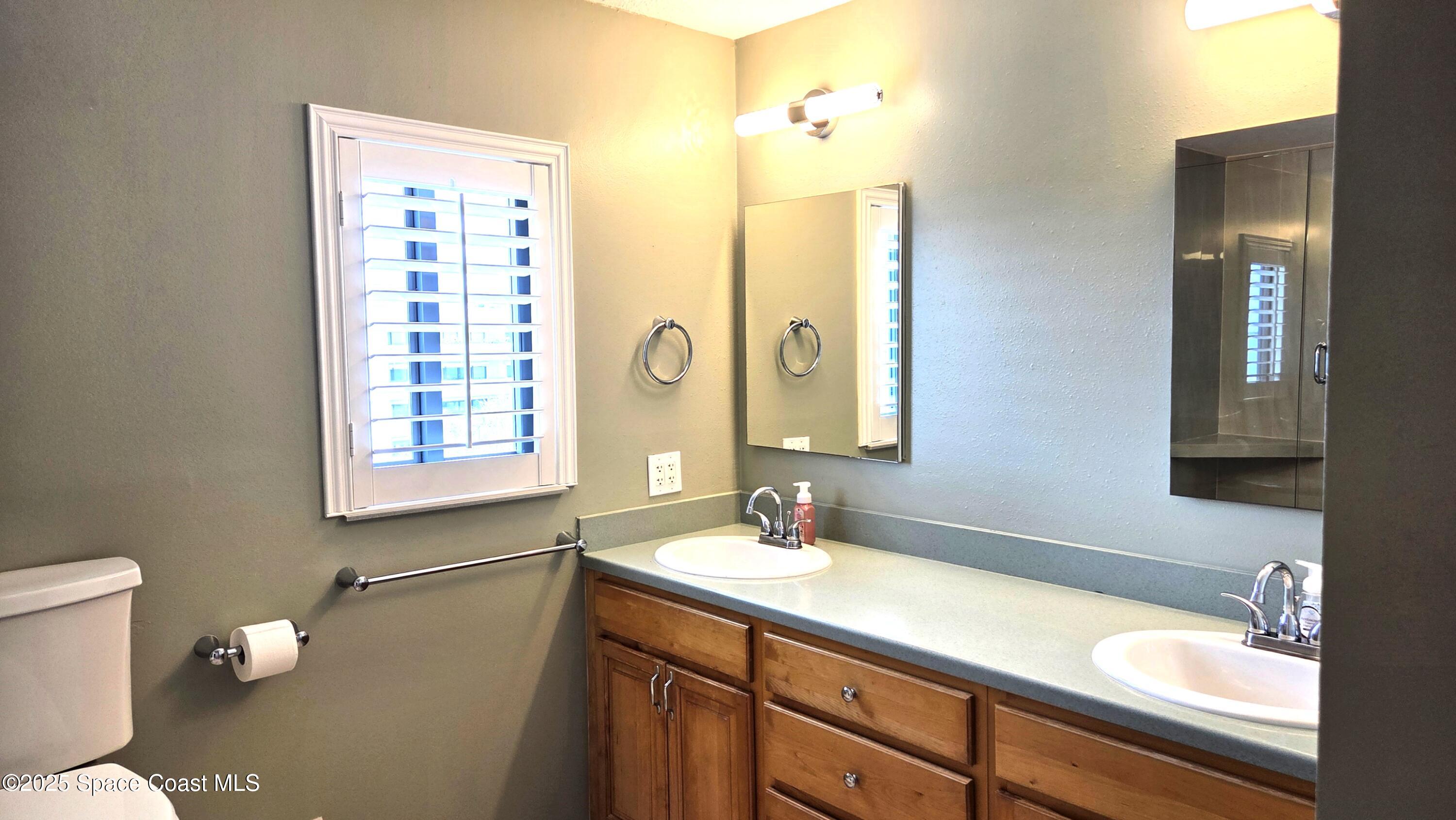 5055 Old Dixie Highway, Unit 403 Palm Bay, FL 32905 - Photo 12 of 32 a bathroom with a sink a toilet and shower