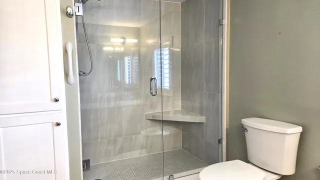 a white toilet sitting next to a bathroom sink