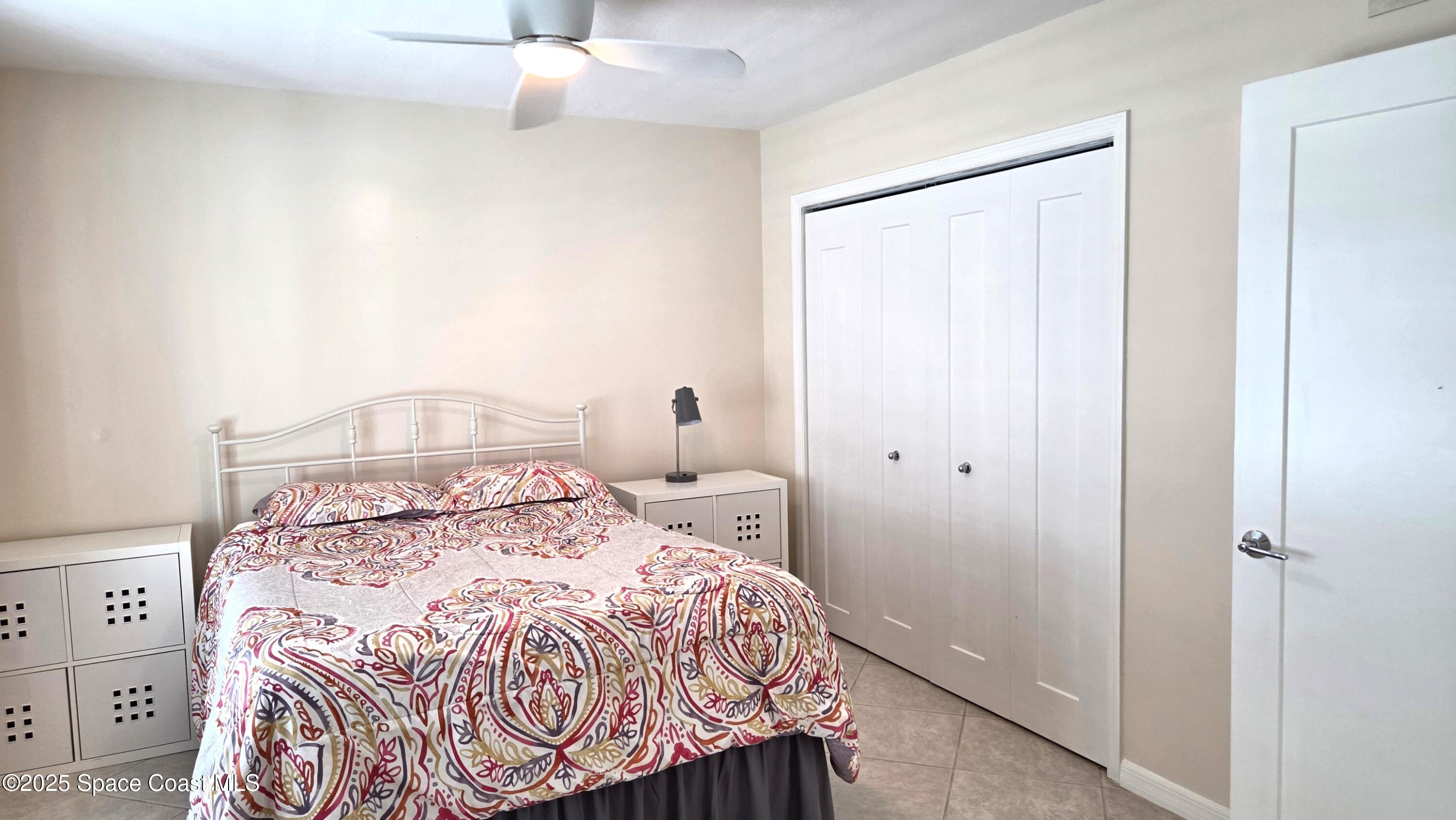 5055 Old Dixie Highway, Unit 403 Palm Bay, FL 32905 - Photo 15 of 32 a bedroom with a bed and a window