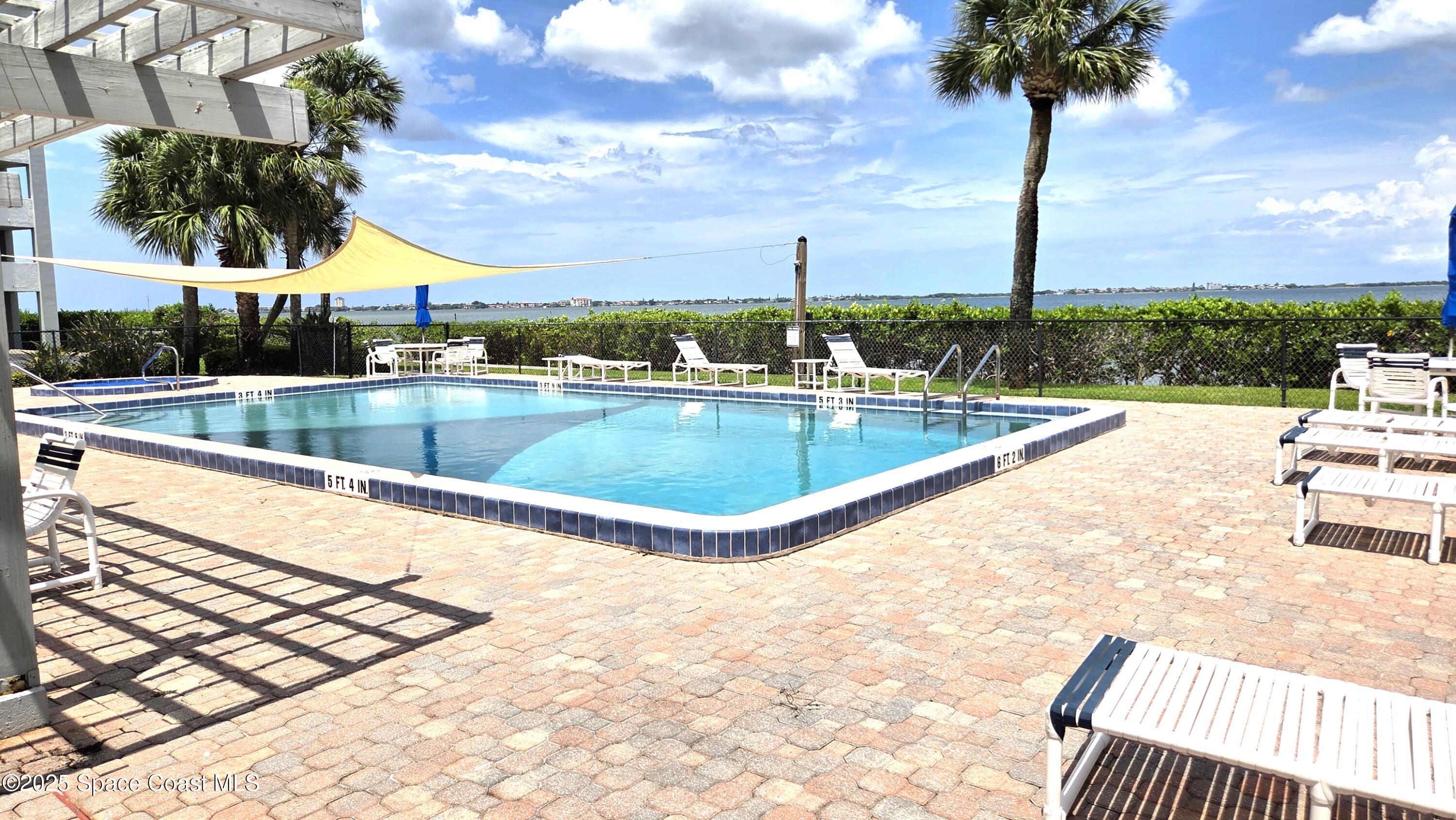 5055 Old Dixie Highway, Unit 403 Palm Bay, FL 32905 - Photo 25 of 32 a view of a swimming pool with a table and chairs