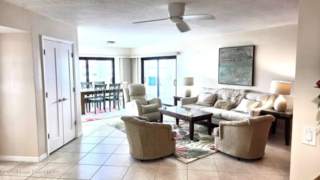 a living room with furniture and large windows