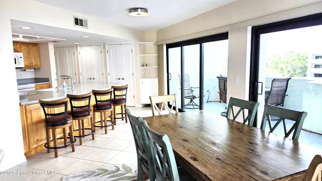a dining room with furniture window and wooden floor