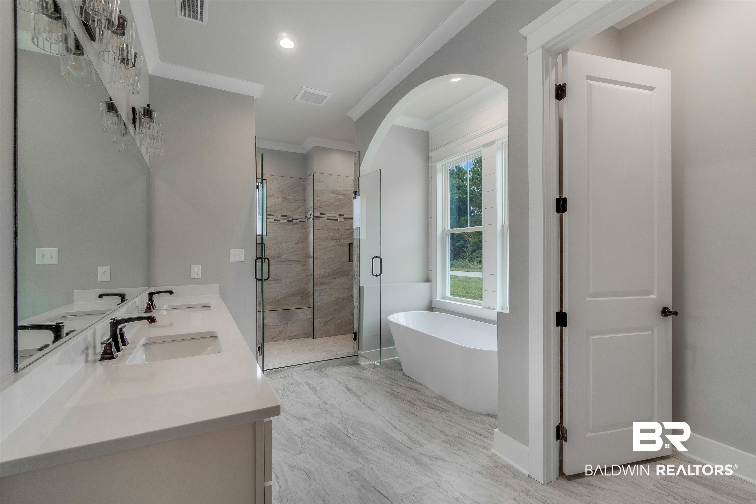 10985 Atrium Avenue Fairhope, AL 36532 - Photo 24 of 58 Full bathroom featuring a stall shower, a freestanding bath, double vanity, ornamental molding, and recessed lighting