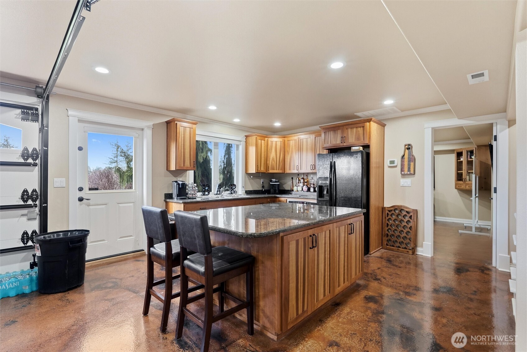 13232 84th Street Southeast Snohomish, WA 98290 - Photo 28 of 40 a kitchen with stainless steel appliances granite countertop a table chairs and a refrigerator