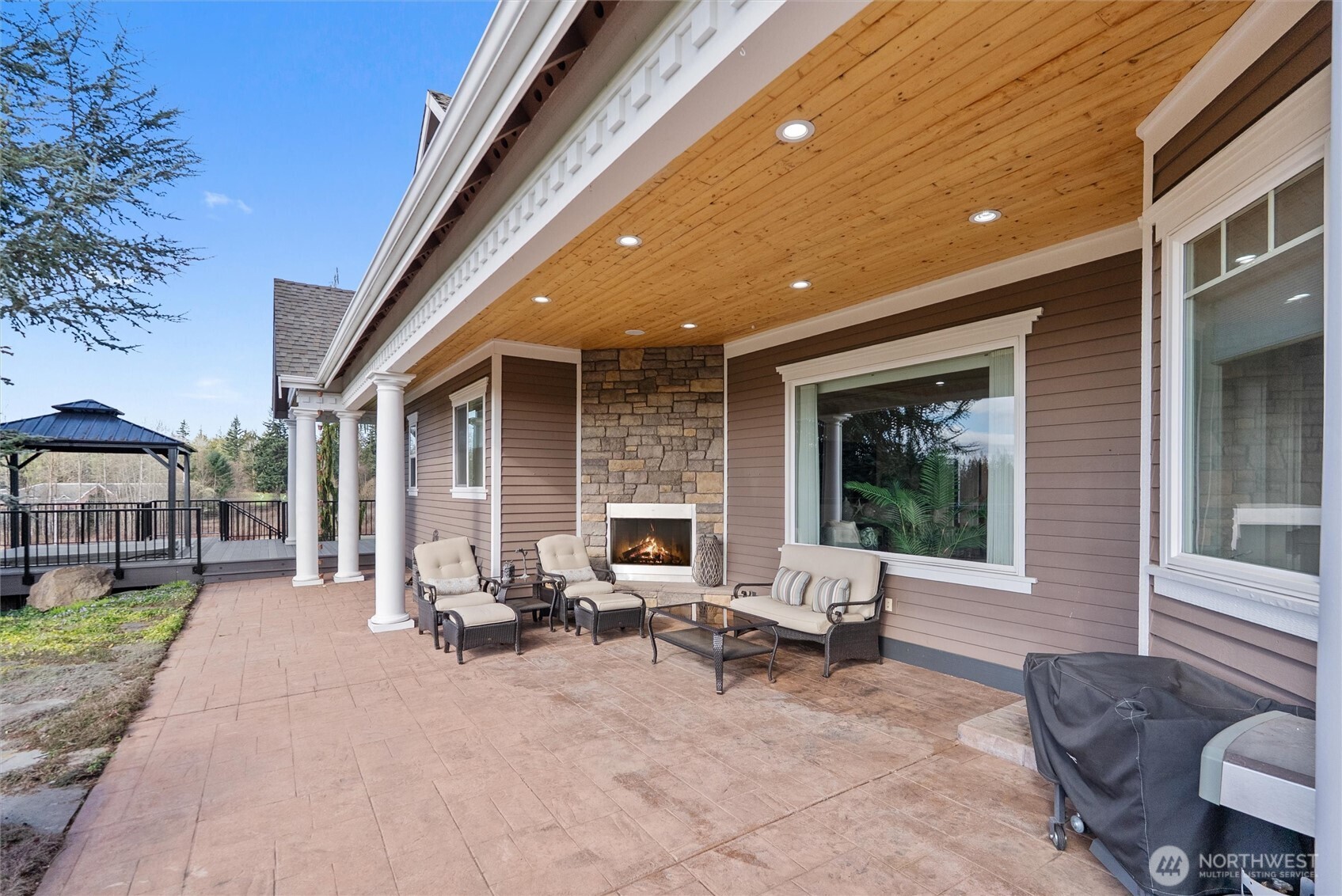 13232 84th Street Southeast Snohomish, WA 98290 - Photo 33 of 40 a view of a patio with a table and chairs under an umbrella with a patio