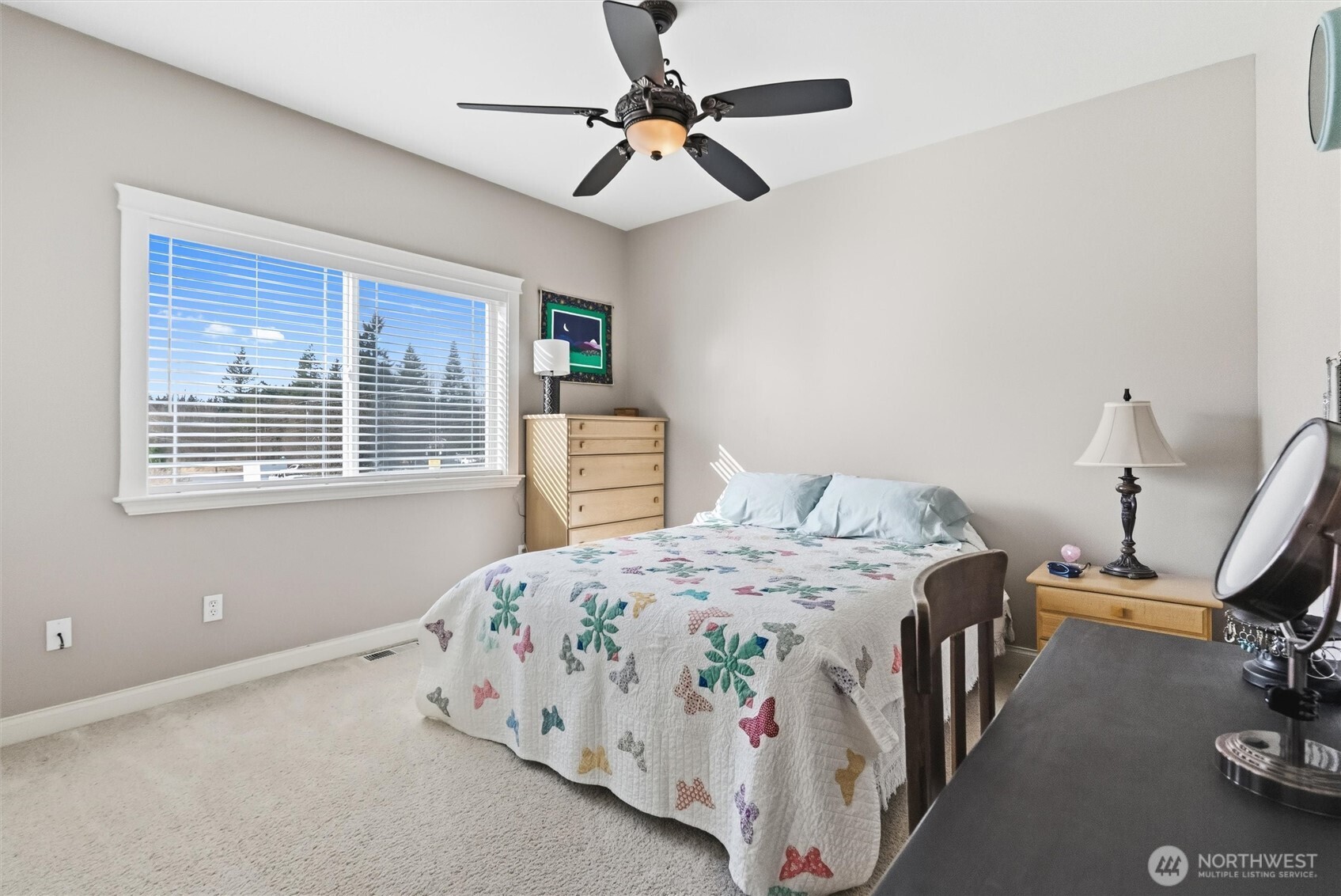 13232 84th Street Southeast Snohomish, WA 98290 - Photo 36 of 40 a bedroom with a bed a chandelier and a window