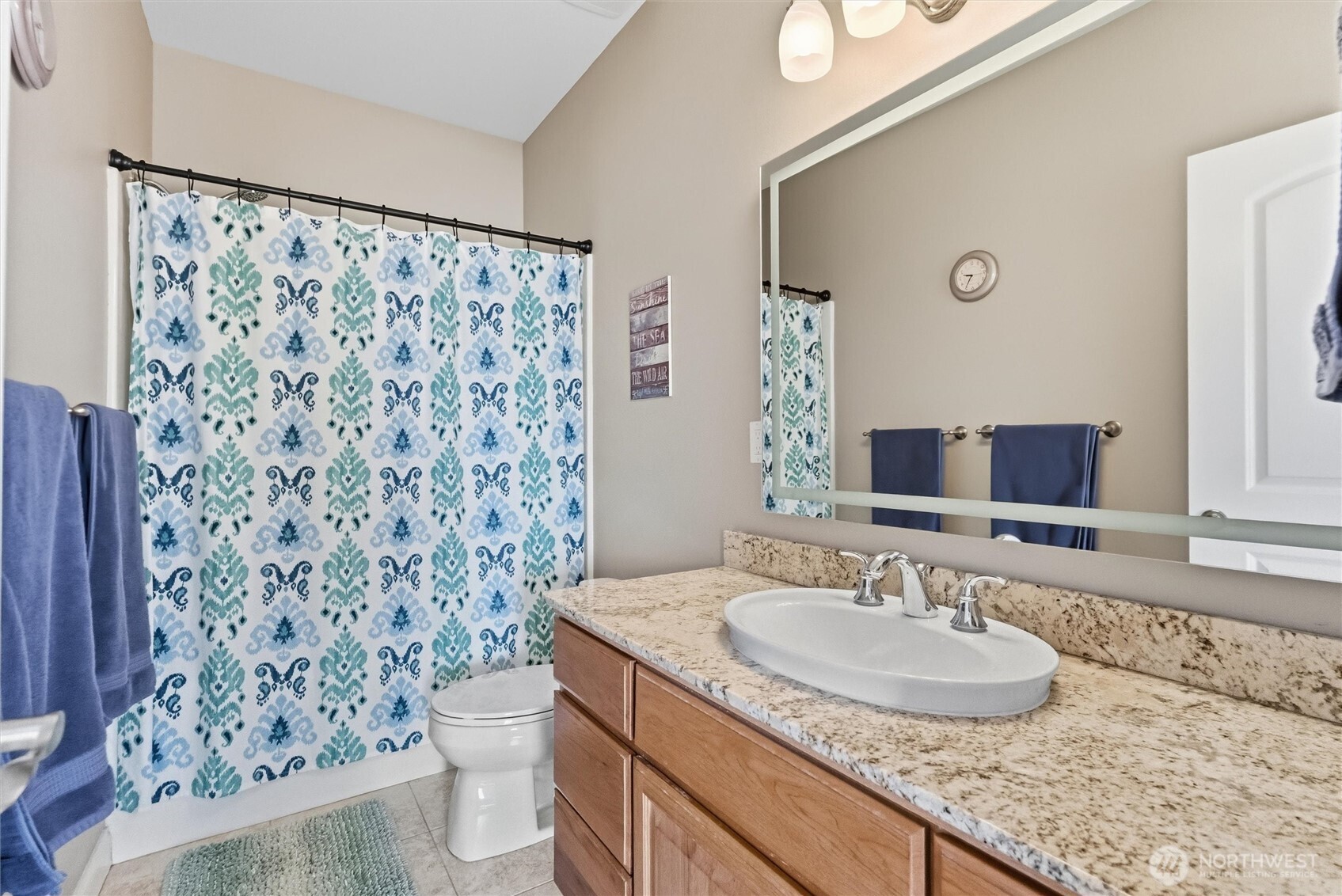 13232 84th Street Southeast Snohomish, WA 98290 - Photo 37 of 40 a bathroom with a granite countertop sink a toilet and a mirror