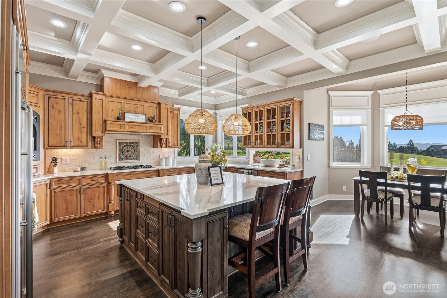 13232 84th Street Southeast Snohomish, WA 98290 - Photo 4 of 40 a kitchen with stainless steel appliances granite countertop a stove a sink a dining table and chairs with wooden floor