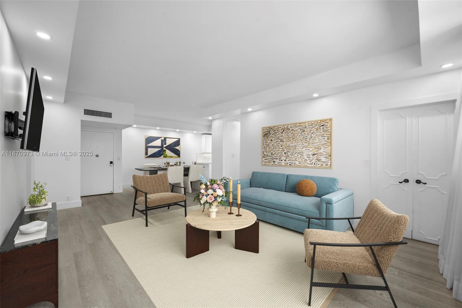 a living room with furniture and wooden floor