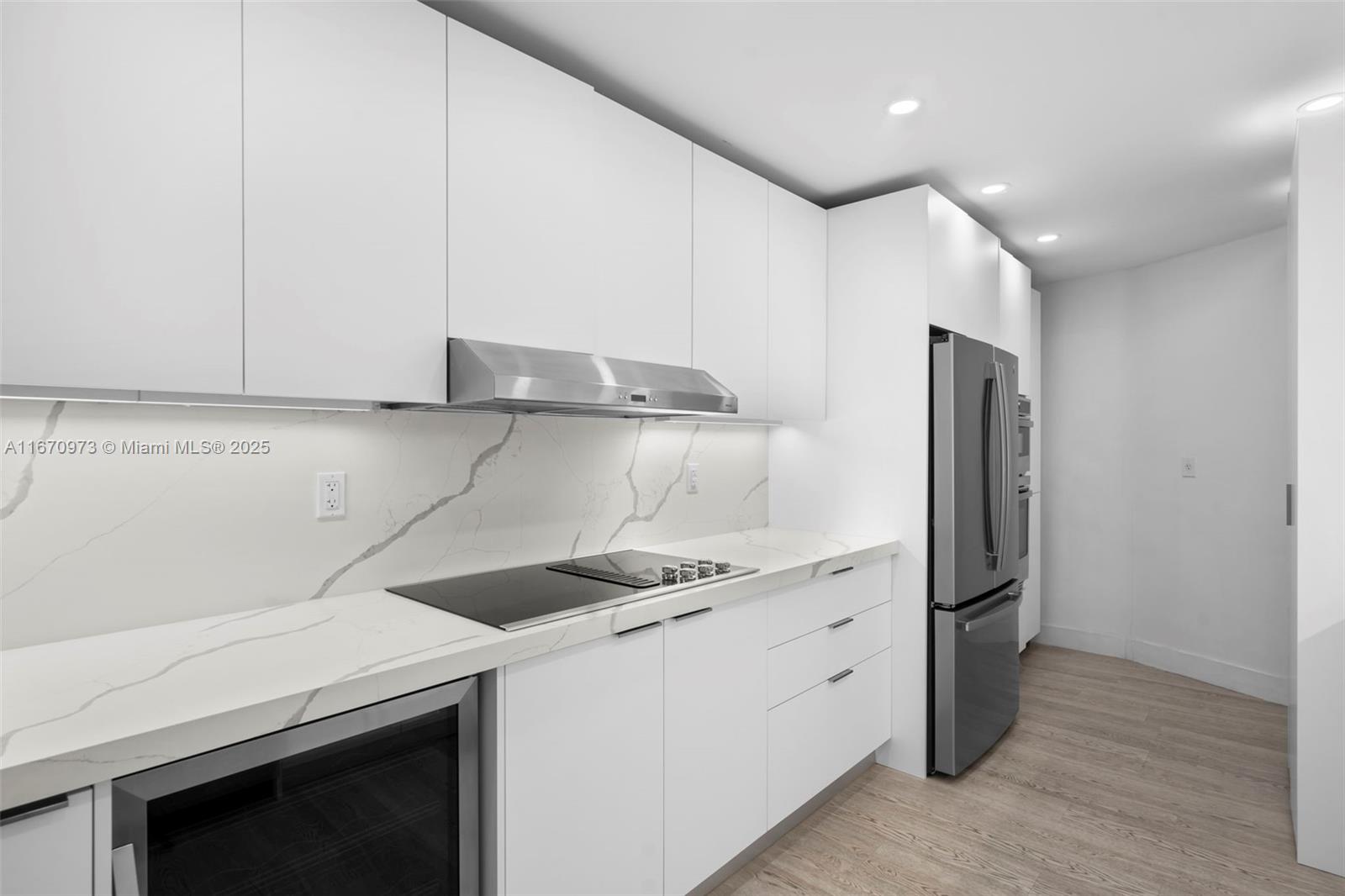 1121 Crandon Boulevard, Unit E105 Key Biscayne, FL 33149 - Photo 12 of 43 a kitchen with a sink and a refrigerator