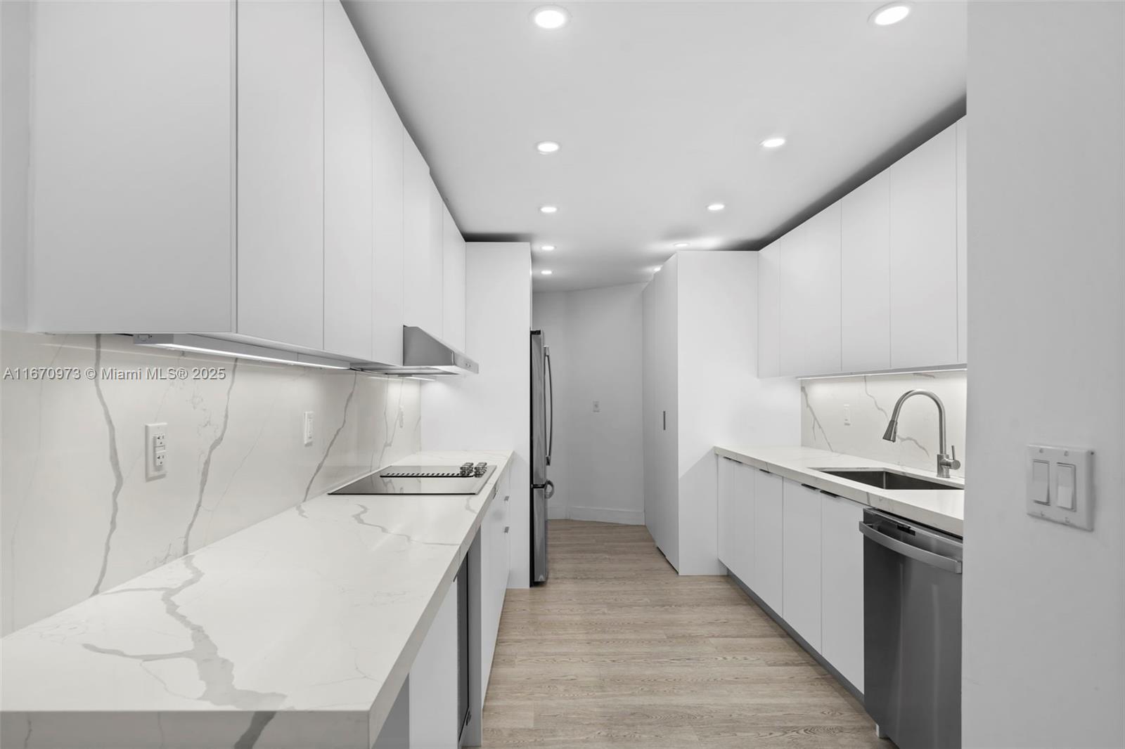 1121 Crandon Boulevard, Unit E105 Key Biscayne, FL 33149 - Photo 13 of 43 a kitchen with cabinets and stainless steel appliances