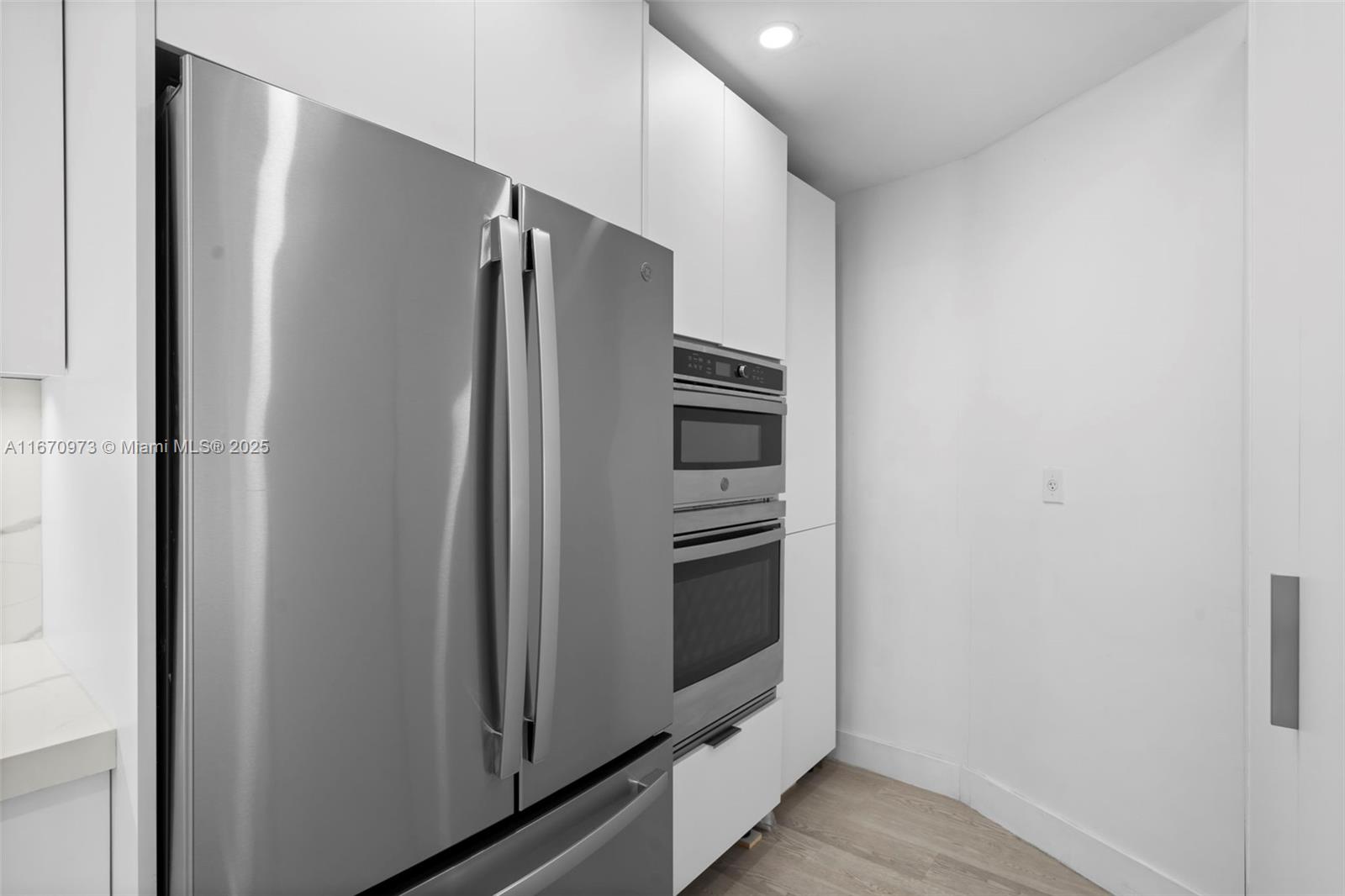 1121 Crandon Boulevard, Unit E105 Key Biscayne, FL 33149 - Photo 14 of 43 a metallic refrigerator freezer sitting in a kitchen