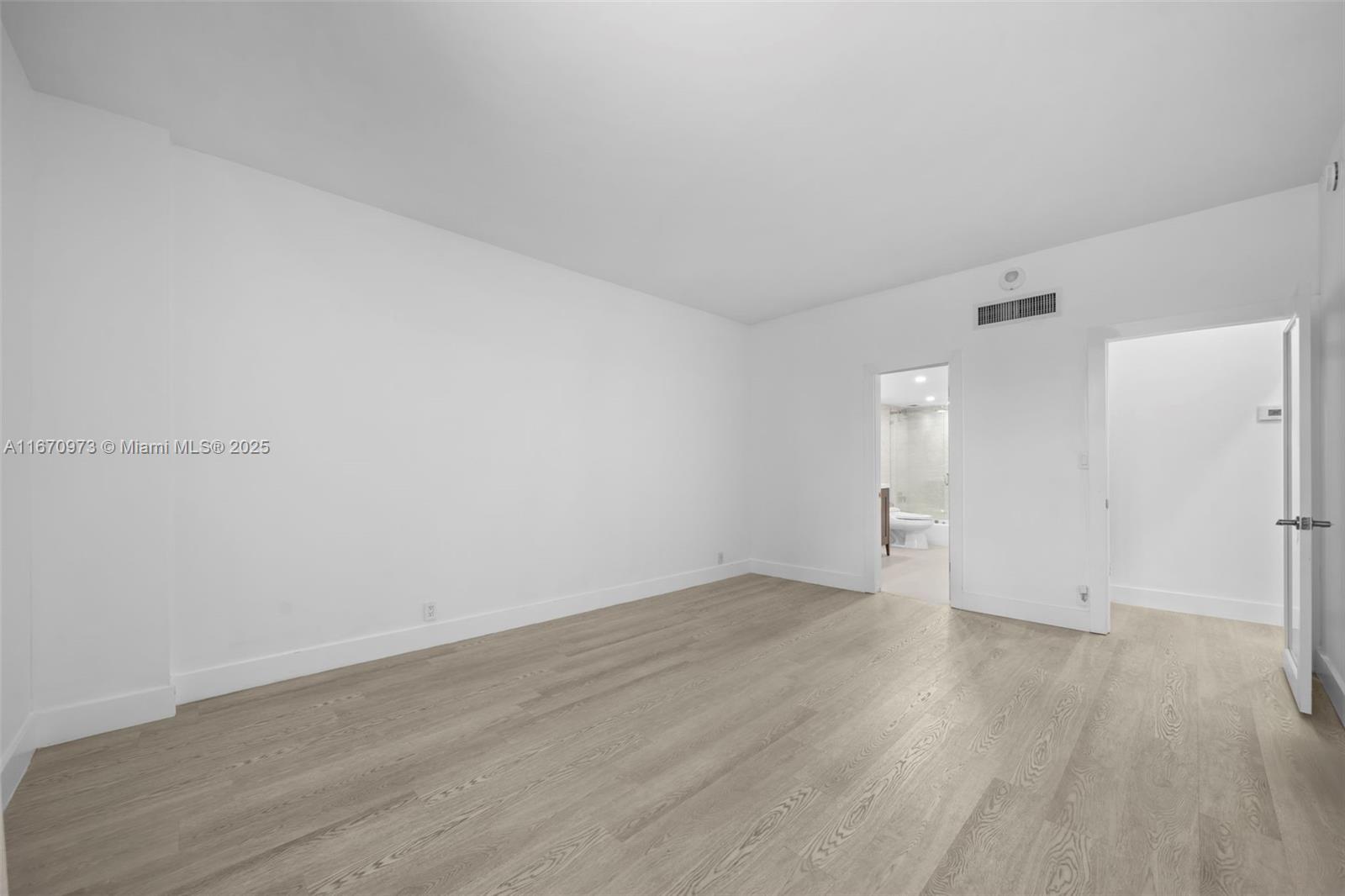 1121 Crandon Boulevard, Unit E105 Key Biscayne, FL 33149 - Photo 21 of 43 an empty room with wooden floor