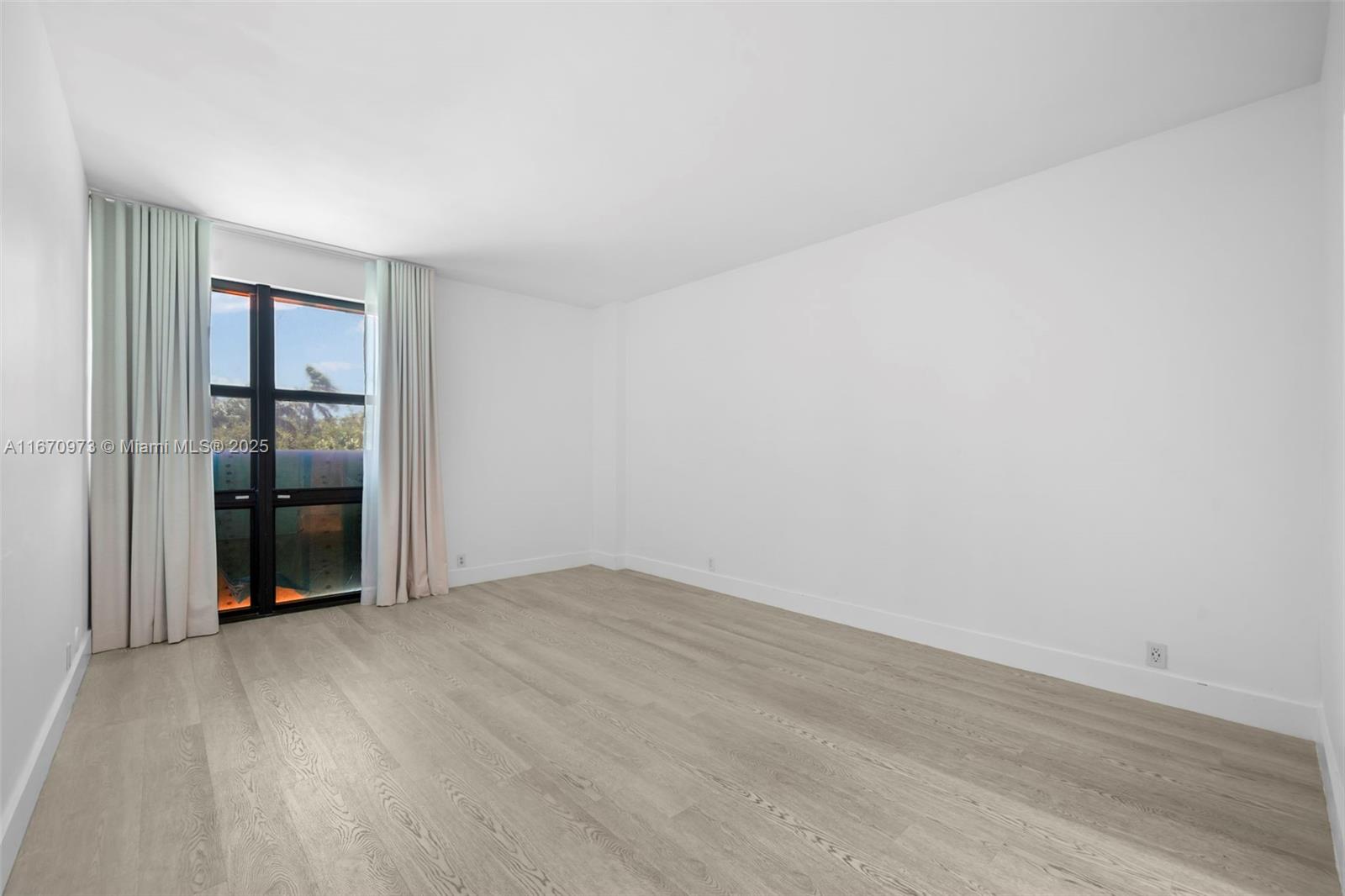 1121 Crandon Boulevard, Unit E105 Key Biscayne, FL 33149 - Photo 23 of 43 a view of an empty room with wooden floor