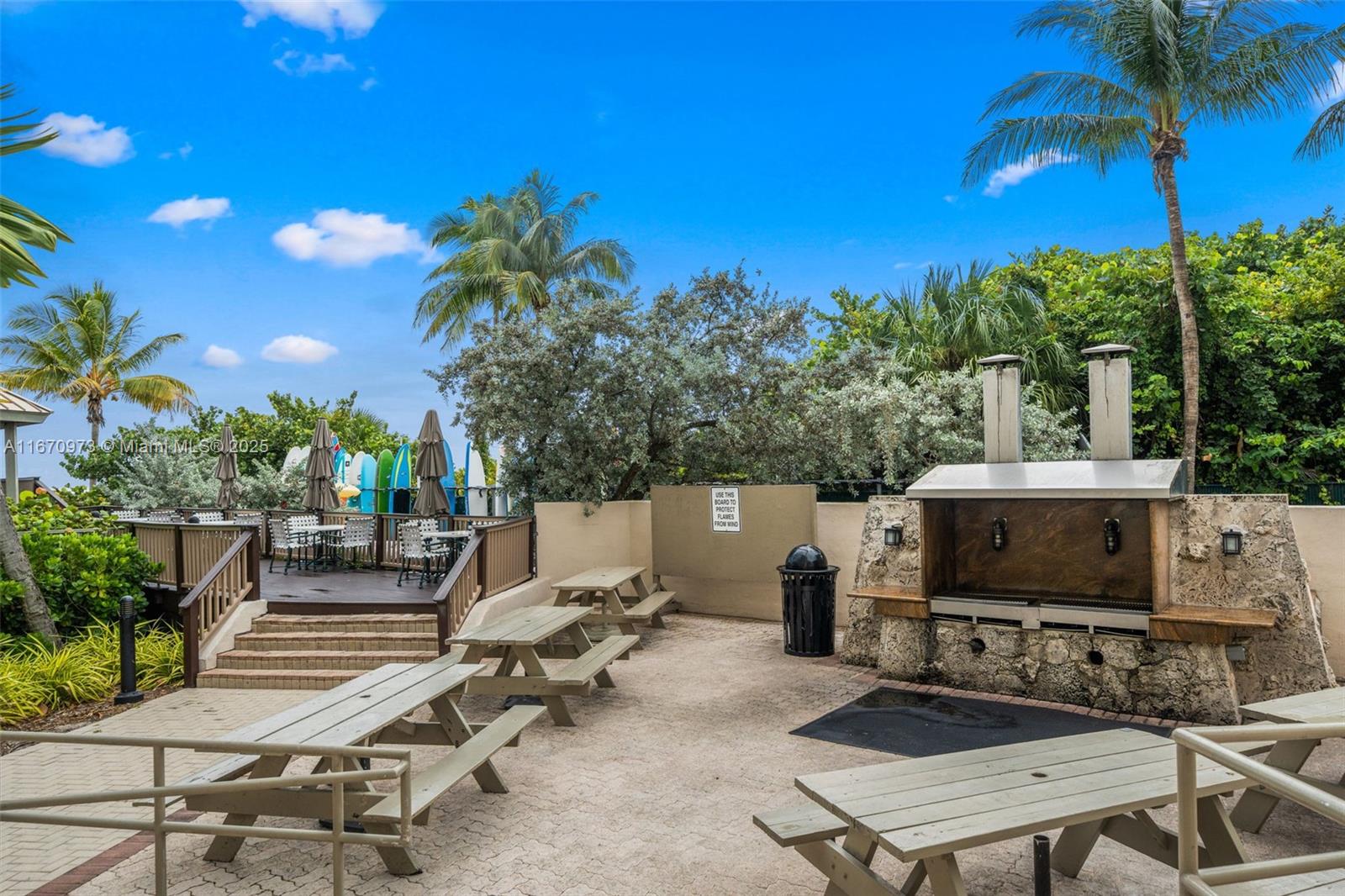 1121 Crandon Boulevard, Unit E105 Key Biscayne, FL 33149 - Photo 38 of 43 a view of a tables and chairs in patio