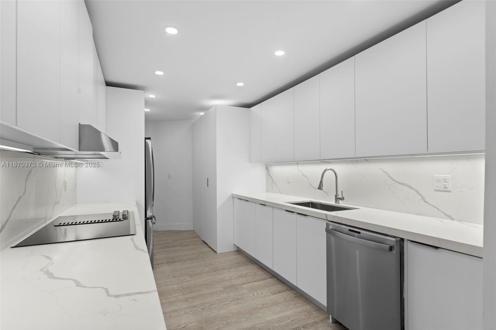 1121 Crandon Boulevard, Unit E105 Key Biscayne, FL 33149 - Photo 5 of 43 a kitchen with a sink and refrigerator