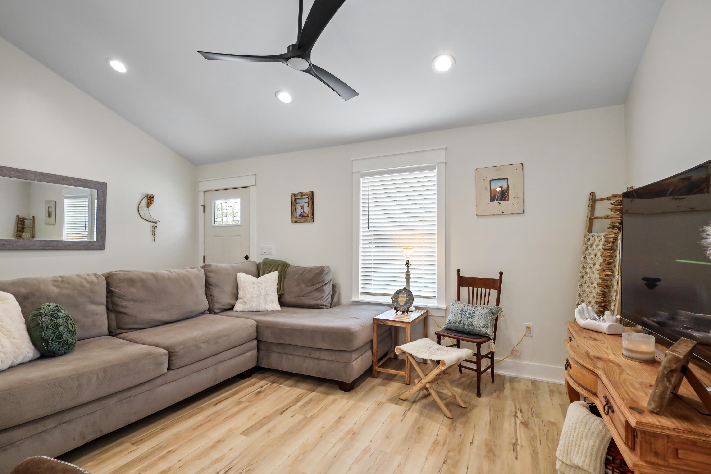71 Lafavre Lane DeFuniak Springs, FL 32433 - Photo 13 of 32 a living room with furniture a flat screen tv and a window
