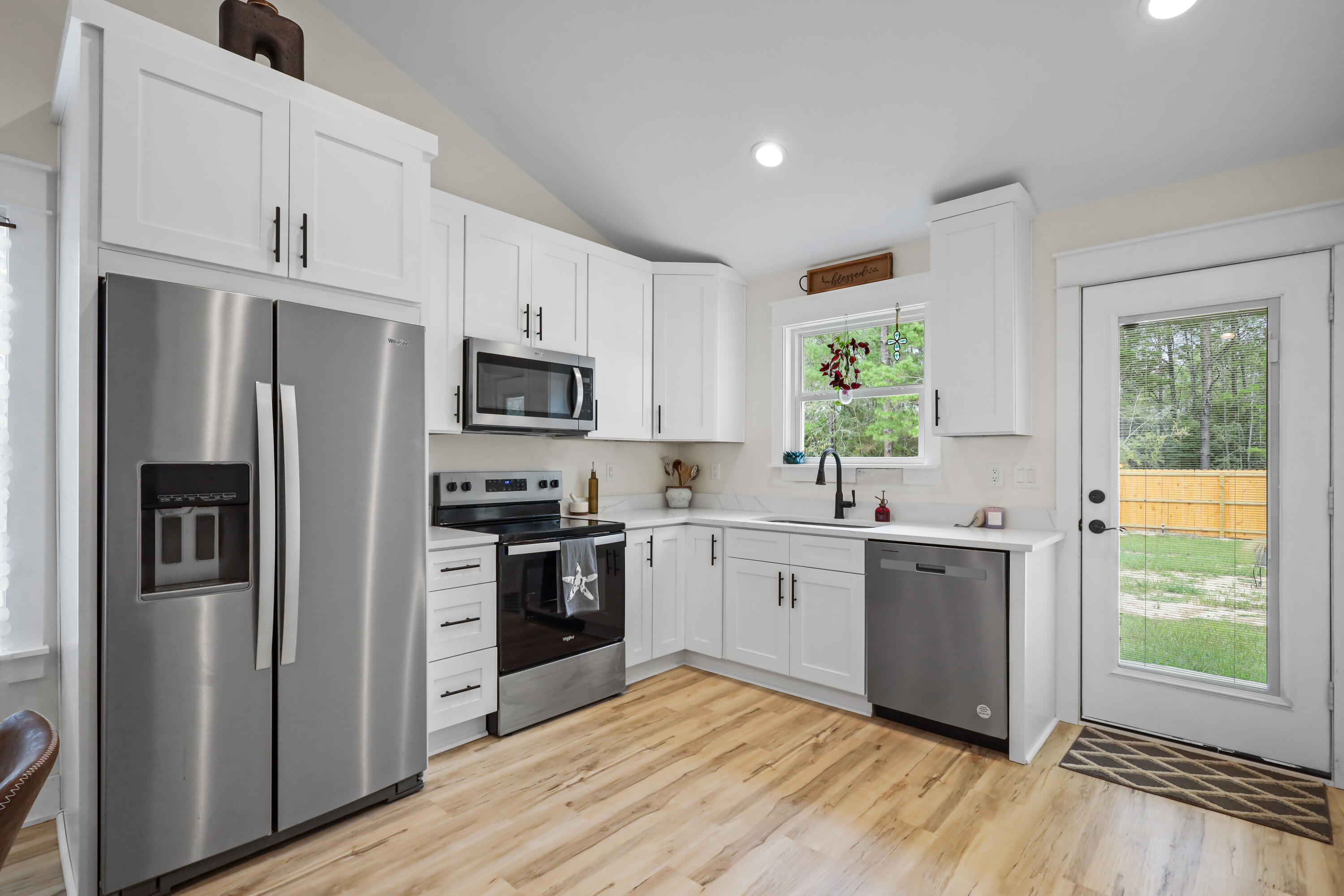 71 Lafavre Lane DeFuniak Springs, FL 32433 - Photo 2 of 32 a kitchen with stainless steel appliances granite countertop a refrigerator a stove a sink and a window