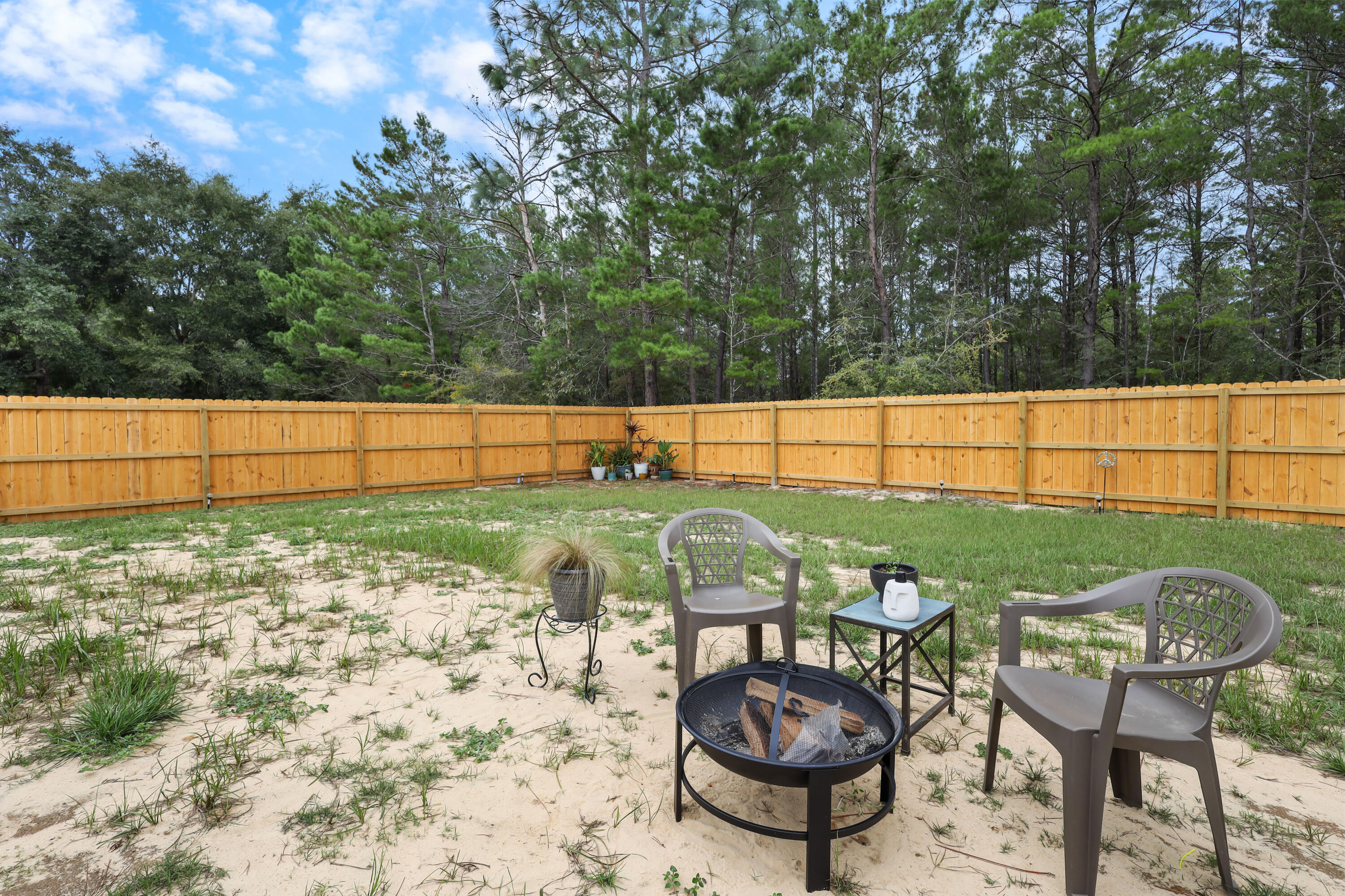 71 Lafavre Lane DeFuniak Springs, FL 32433 - Photo 24 of 32 a view of a chairs and table in the backyard