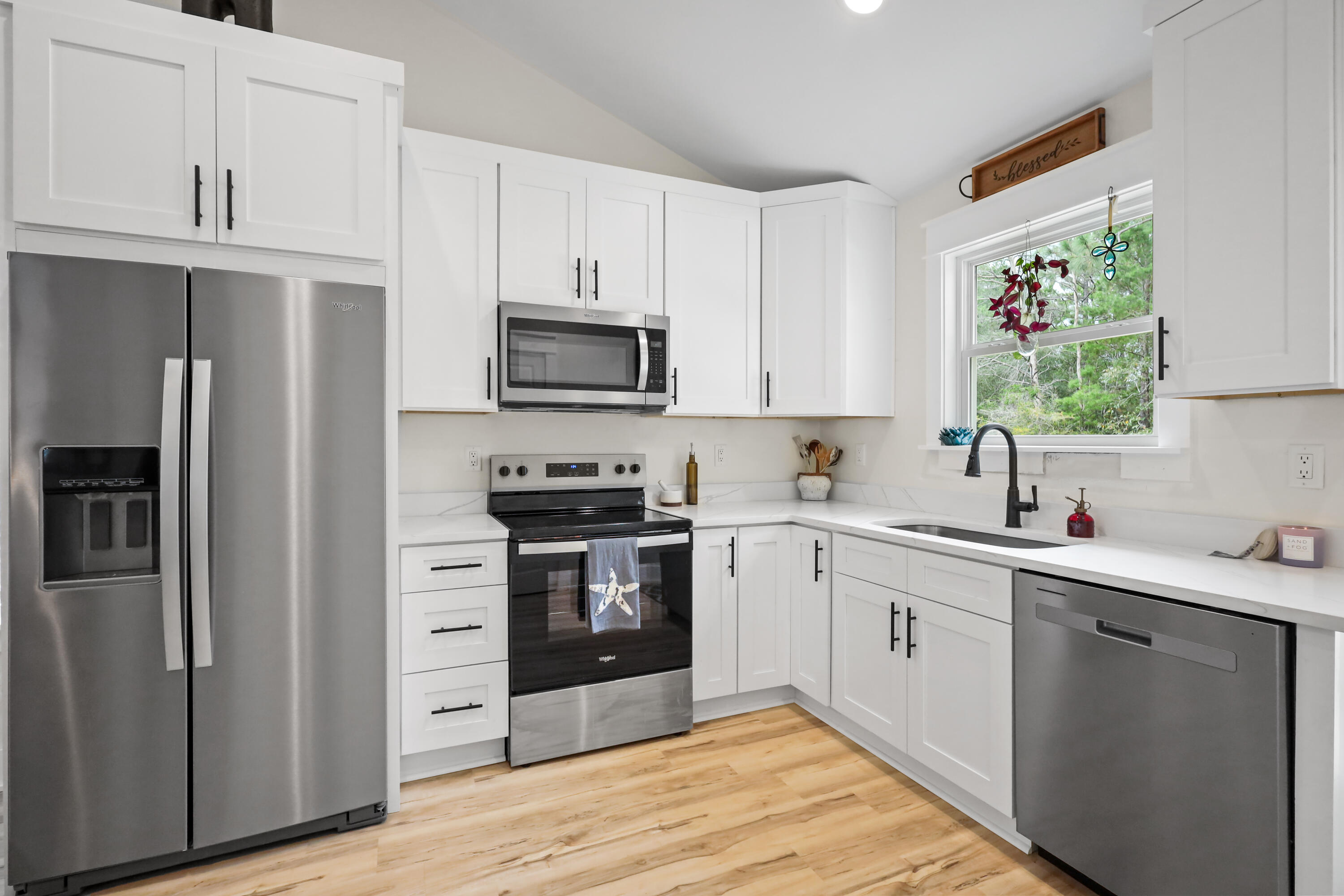 71 Lafavre Lane DeFuniak Springs, FL 32433 - Photo 3 of 32 a kitchen with stainless steel appliances a sink cabinets and a window