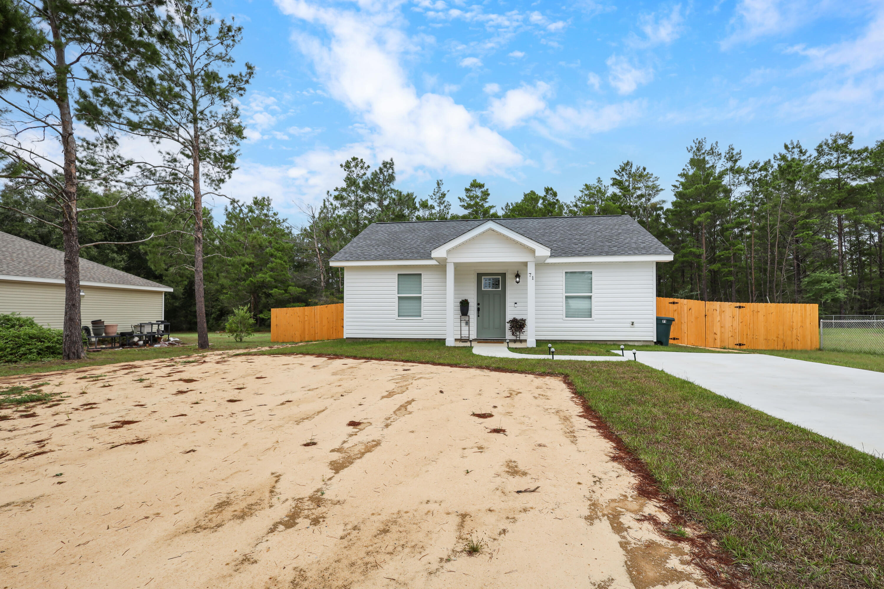 71 Lafavre Lane DeFuniak Springs, FL 32433 - Photo 31 of 32 a front view of house with yard and trees in the background
